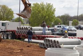 Commercial plumbers in Berkeley CA work on a large scale pipe installation